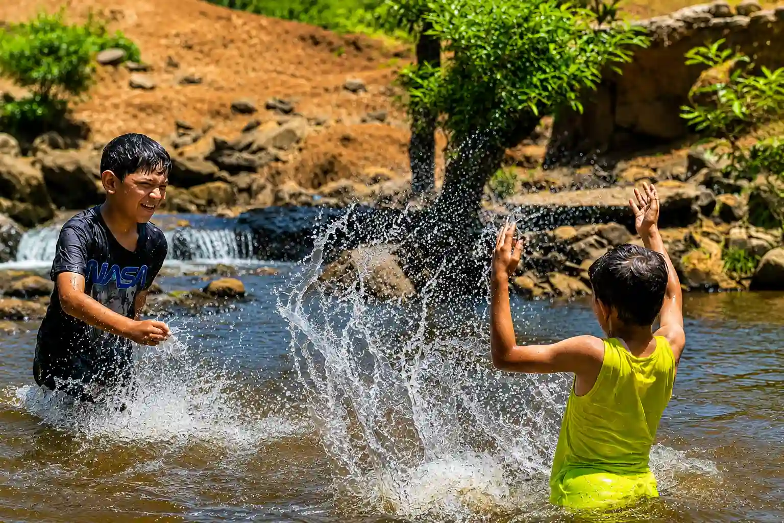 Children enjoying a river adventure in nature at Nisargshala